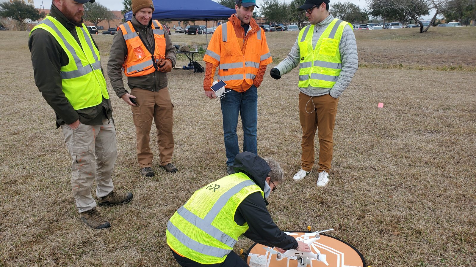 Group of GIS students getting the drone set to start the obstacle course.