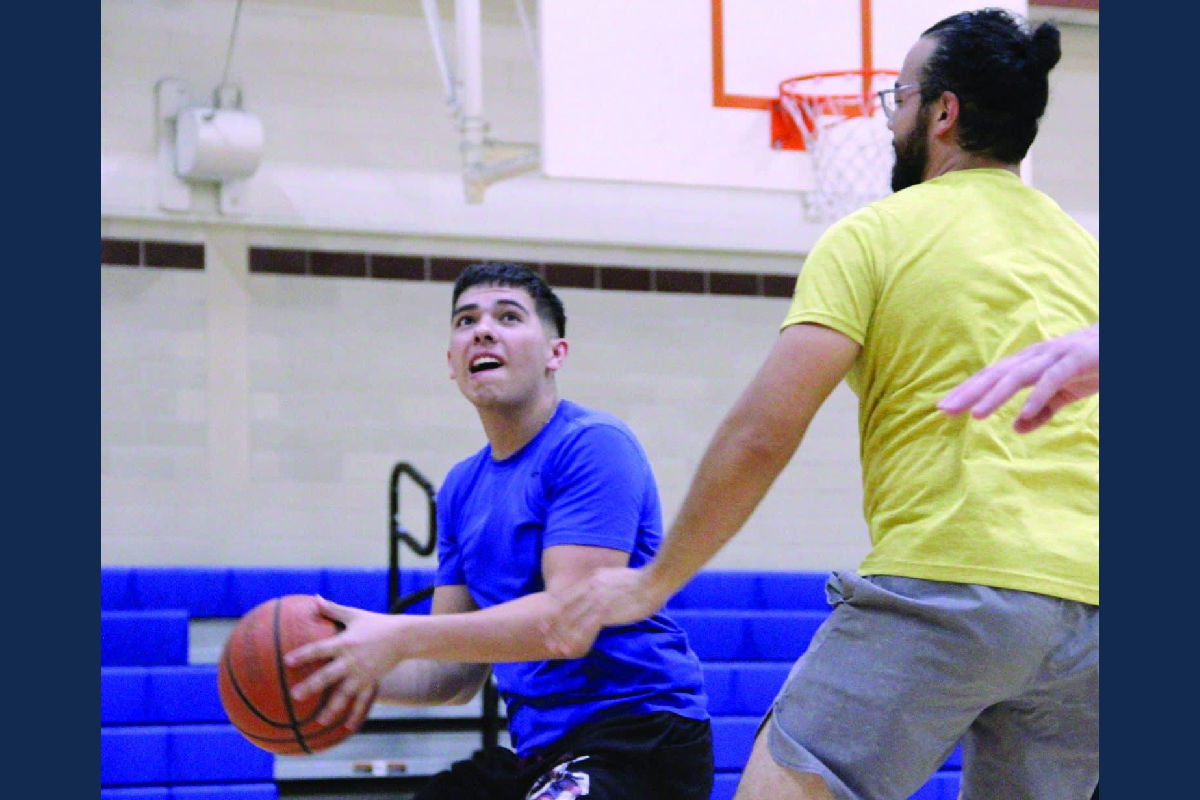 Two students playing basketball