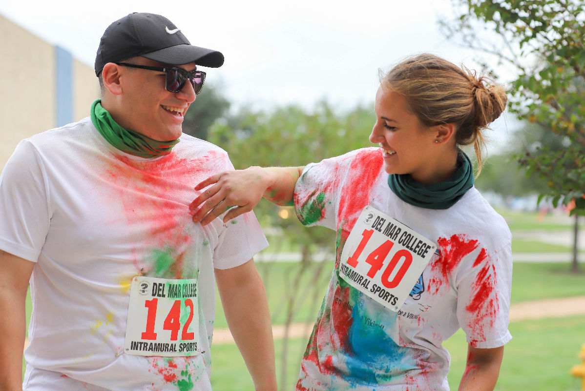 Two run participants with paint powder on them