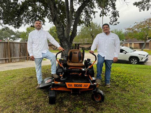 Lawncare business partners standing by lawnmore