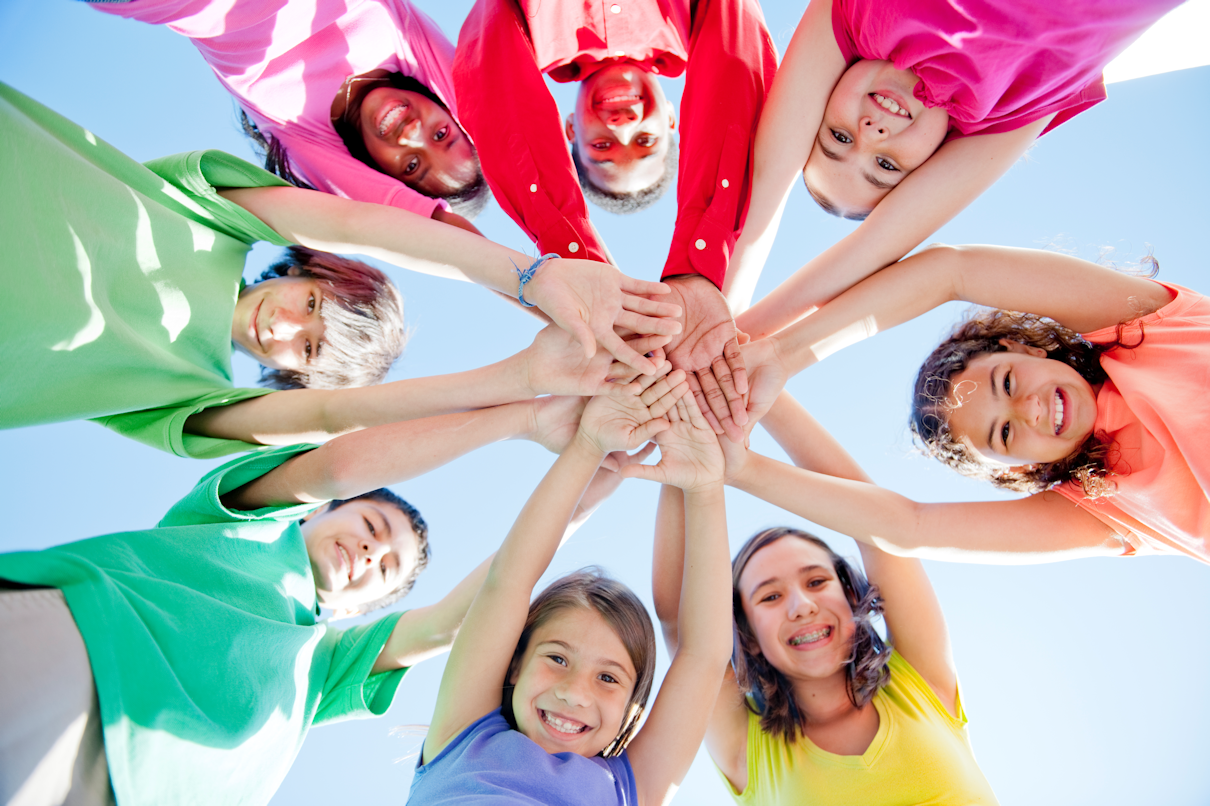 A group of children in a circle holding hands