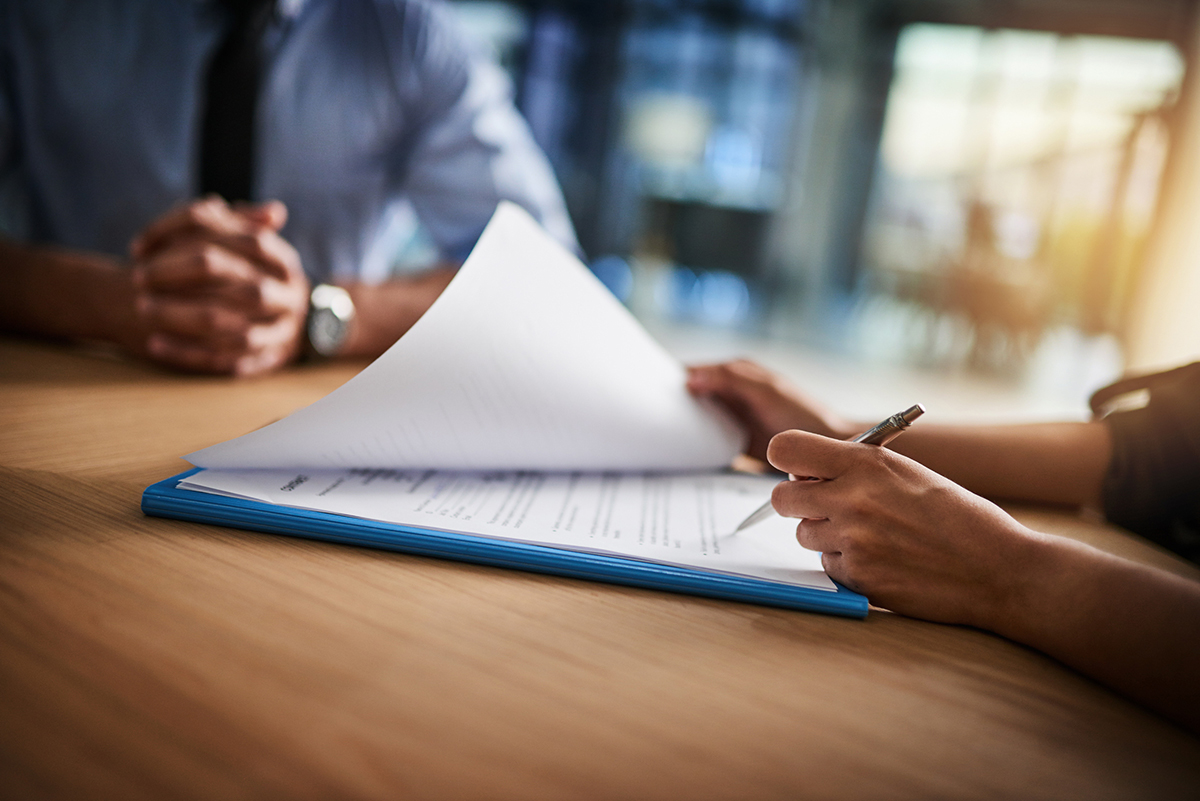 Closeup of two people working at a desk