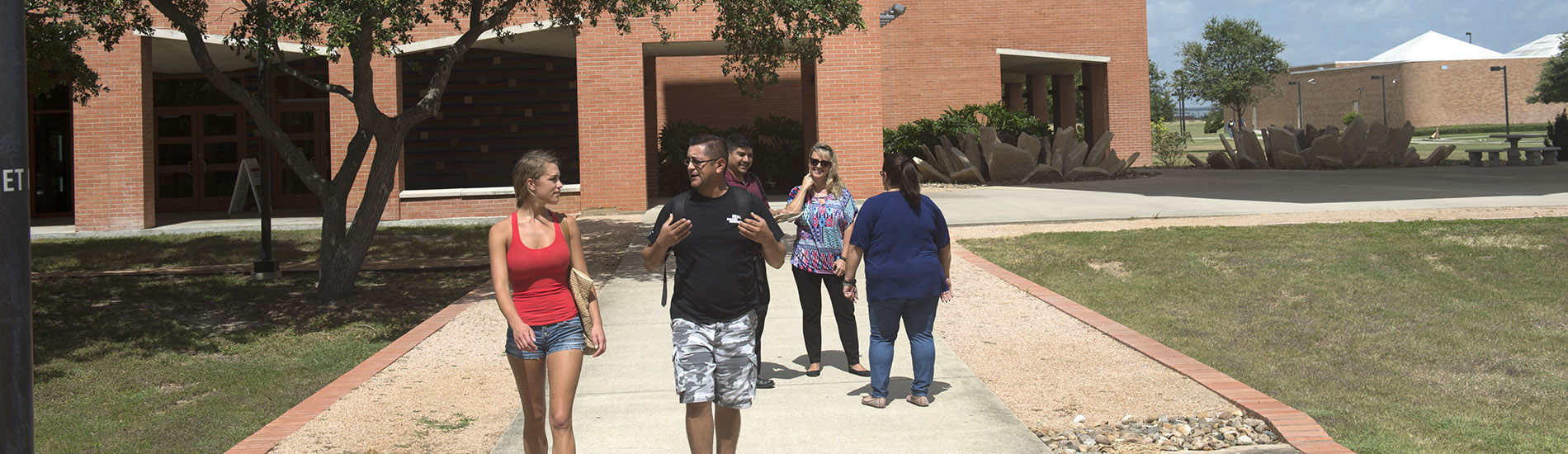 Students walking between Health Sciences and Emerging Technologies on West Campus