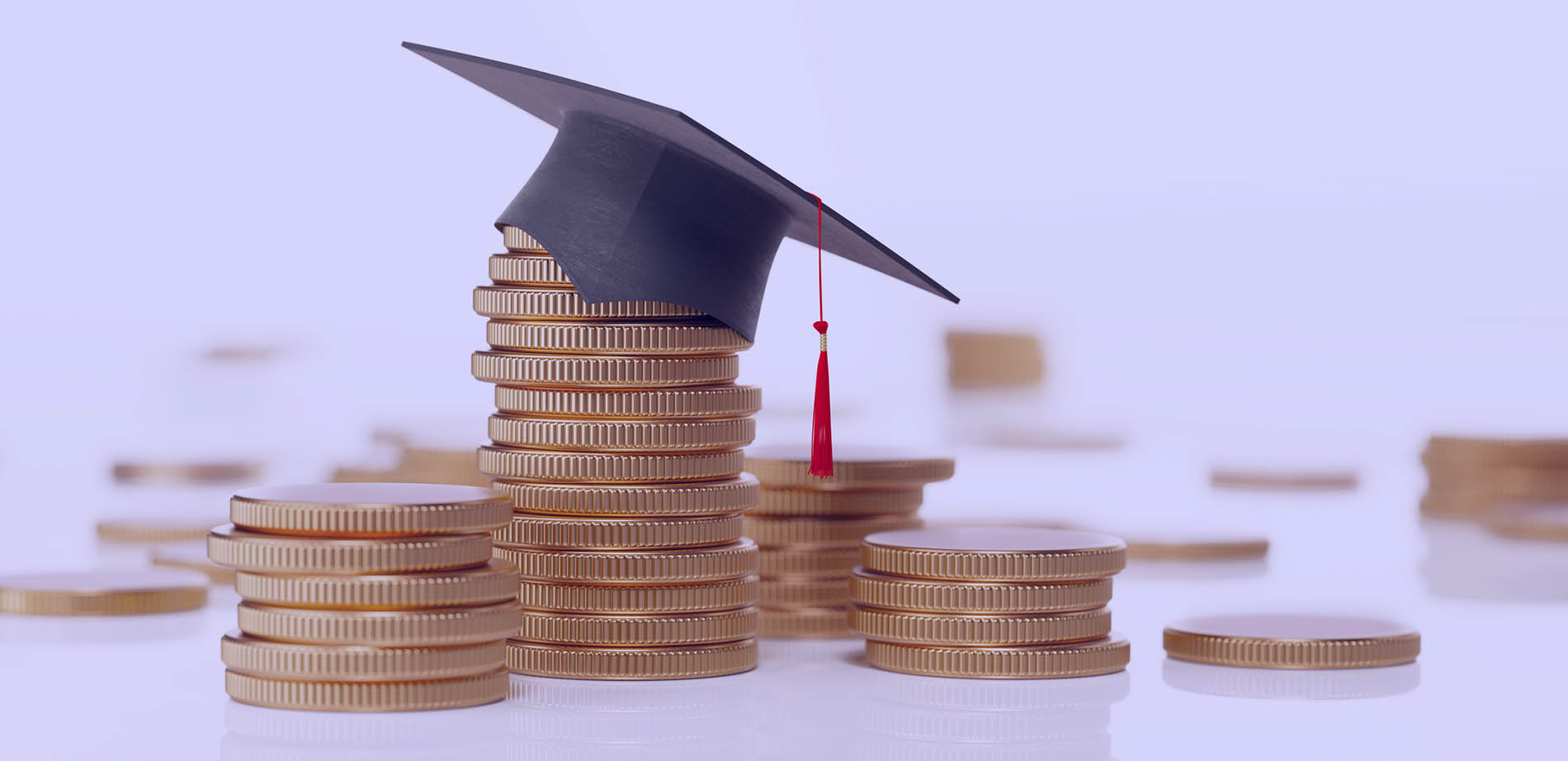 A graduation cap atop a stack of coins