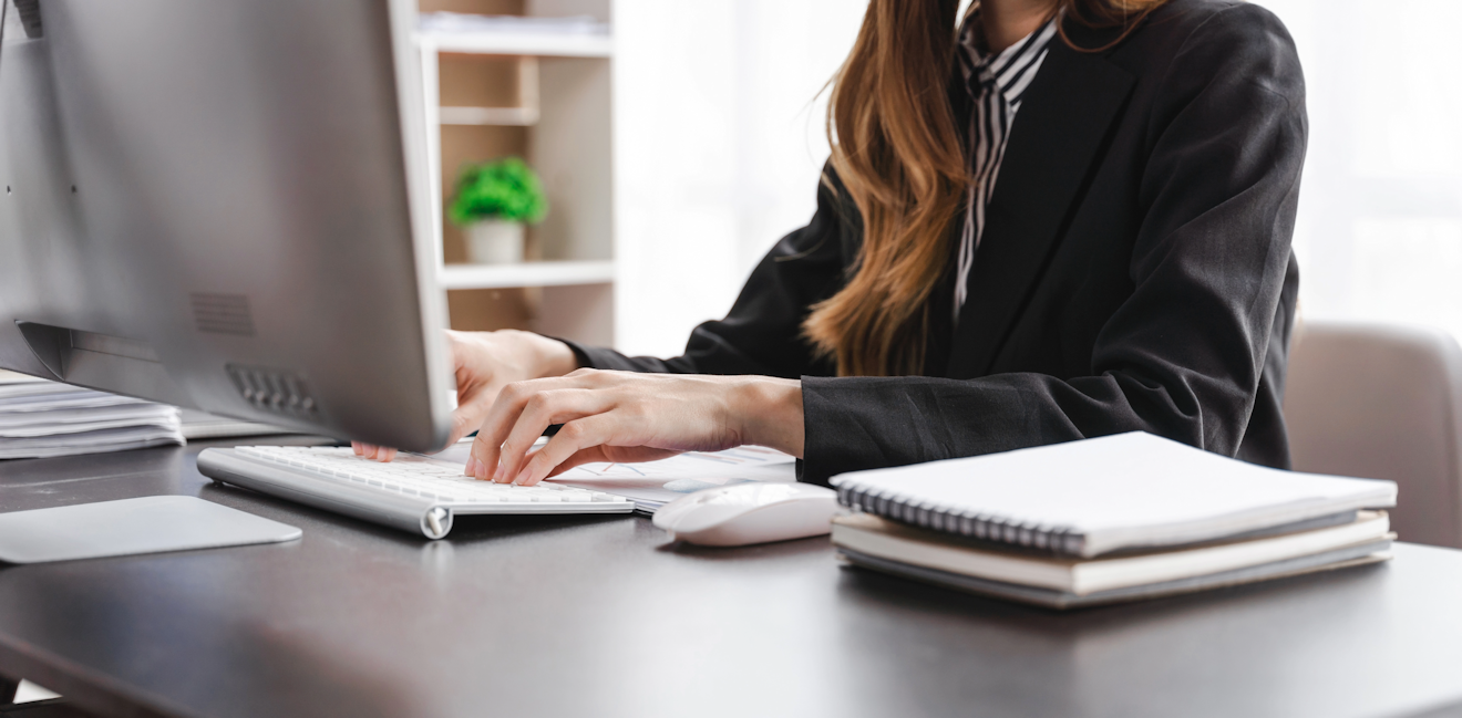 Closeup of administrative assistant working at a computer