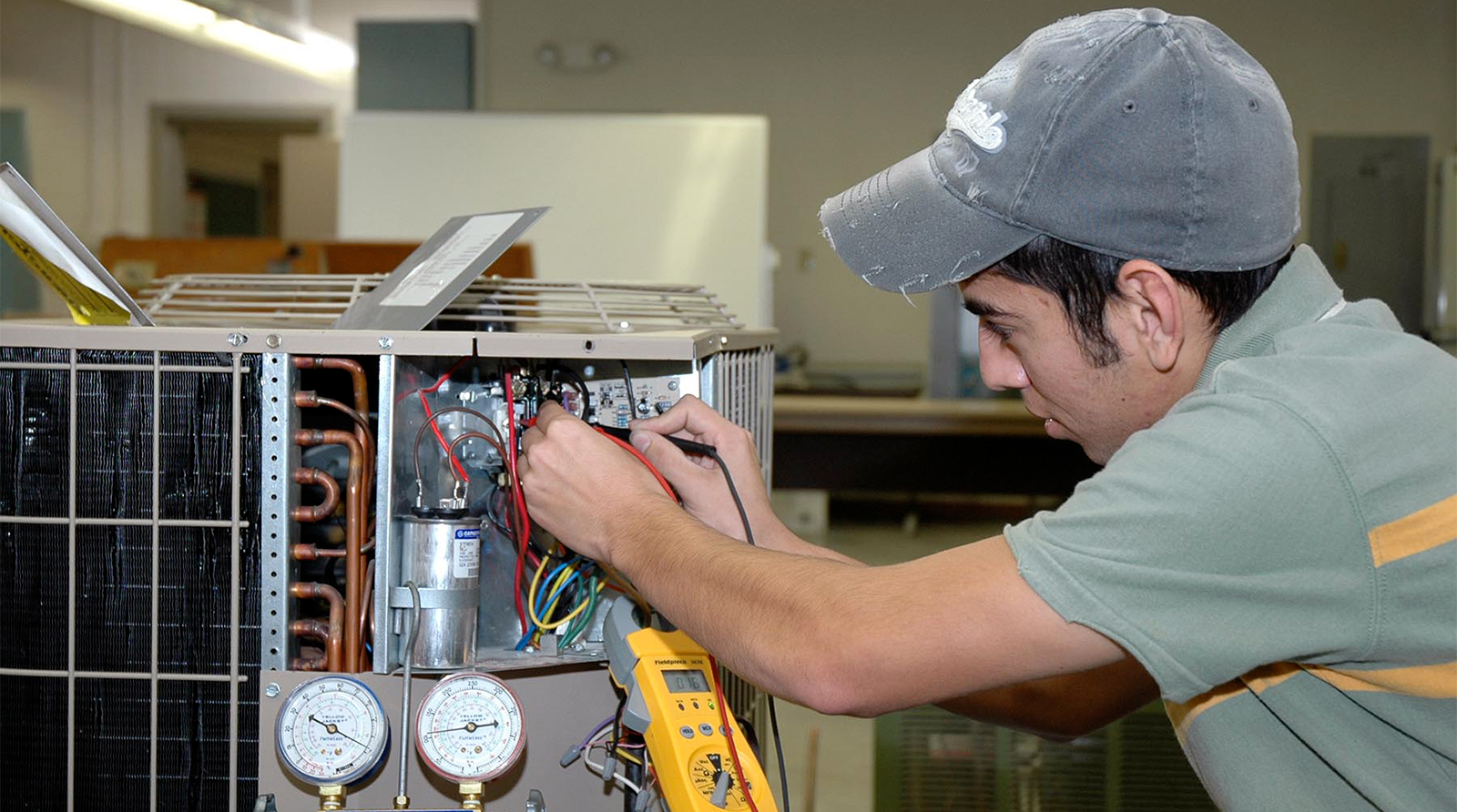 Student works on an AC unit