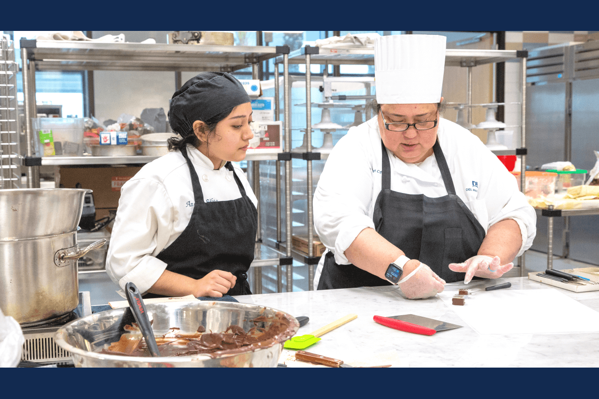 Chef Claudia instructs baking student in state of the art kitchen