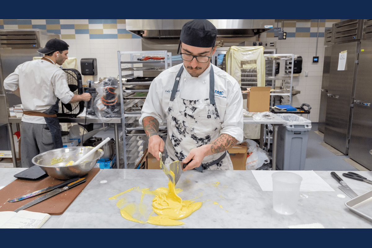 Baking student prepares white chocolate in kitchen classroom