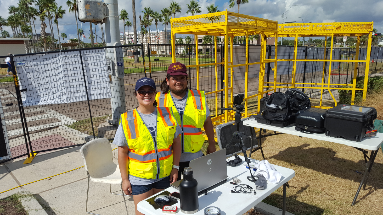 Two GIS students outside at a table with equipment