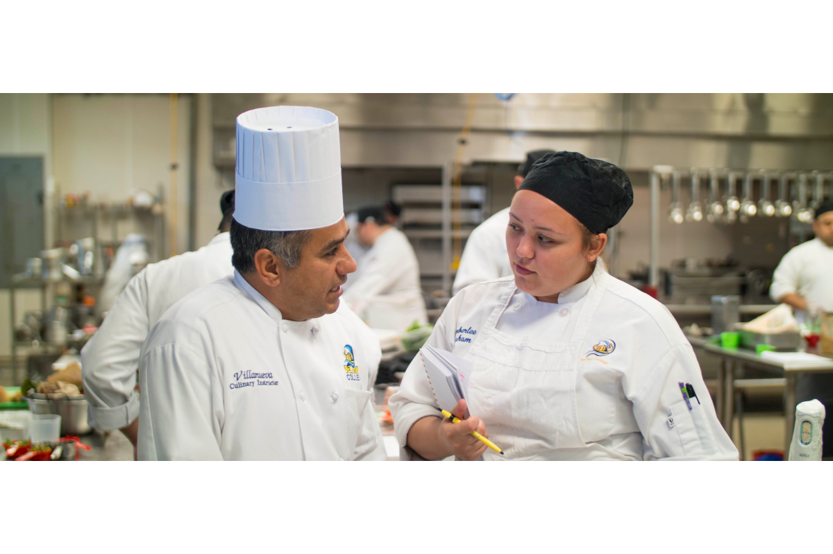 Culinary instructor speaks with a student