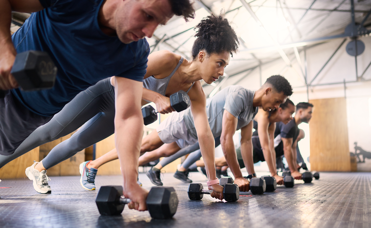 People working out in the gym with dumbbells