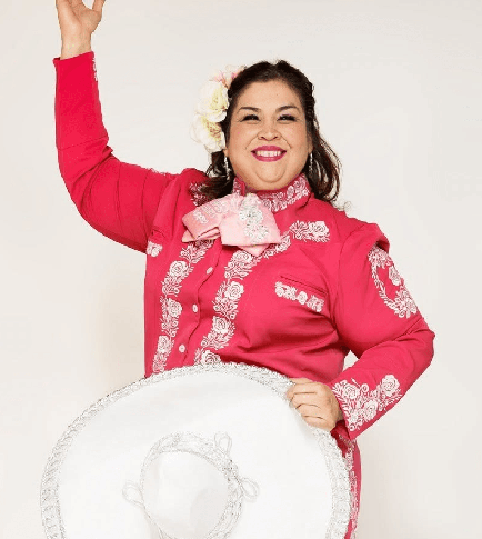 Margaret Rodriguez in a bright pink mariachi outfit with a white mariachi sombrero