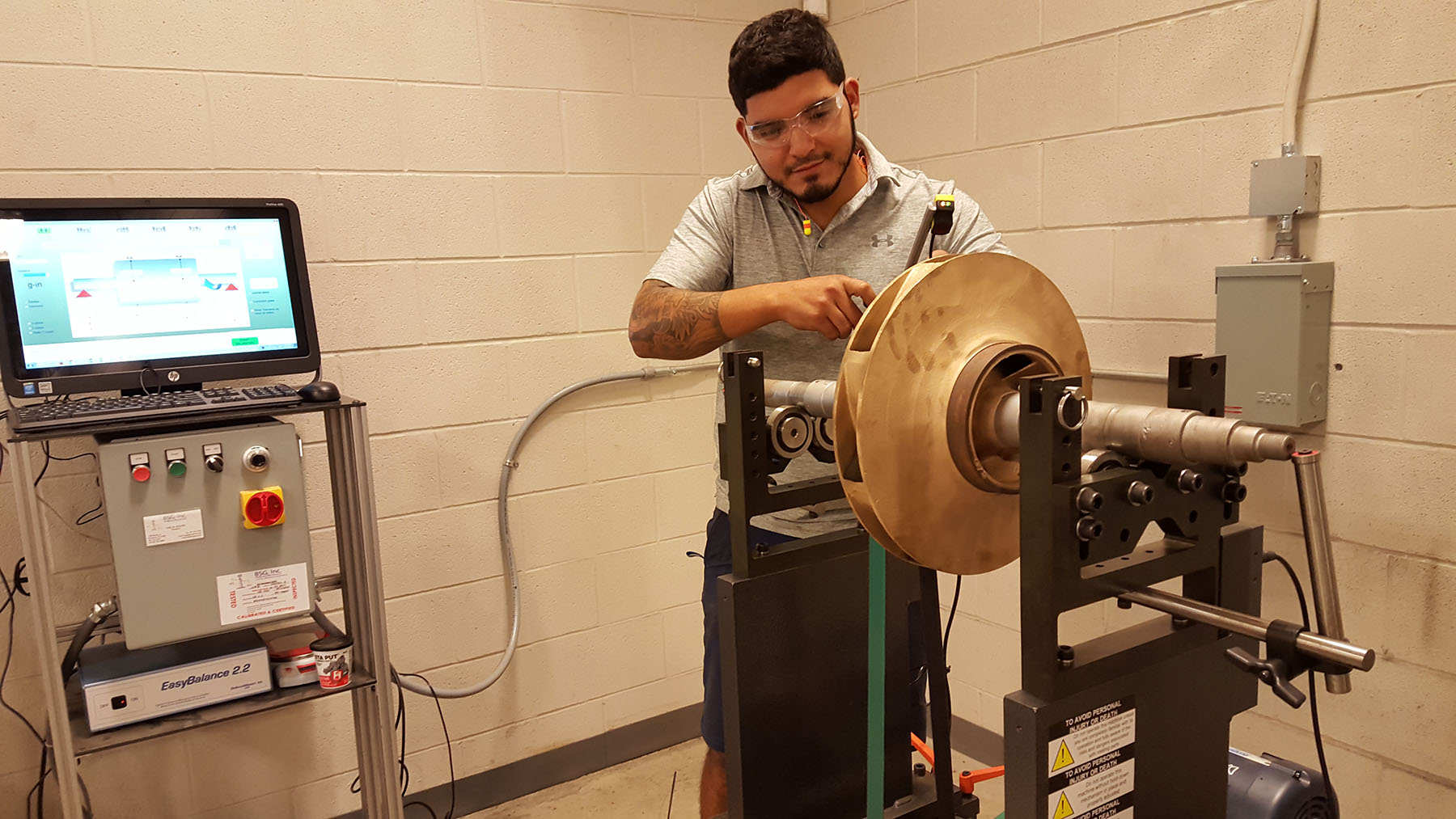Eric Pena preps an impeller to be balanced on a dynamic balancing machine.