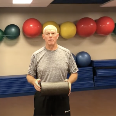 Professor Gene Power holds a foam "roller" fitness workout tool.