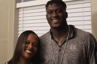 Je'Sani Smith, tall and athletic, towers over his mom in this image.
