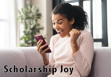 Happy, mixed-ethnicity female student receives scholarship notice on her phone.
