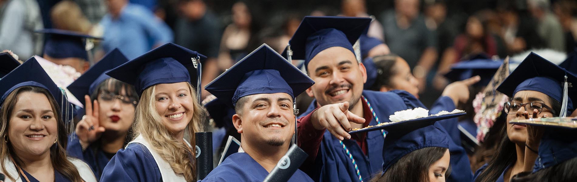 A group of graduates smiling and celebrating