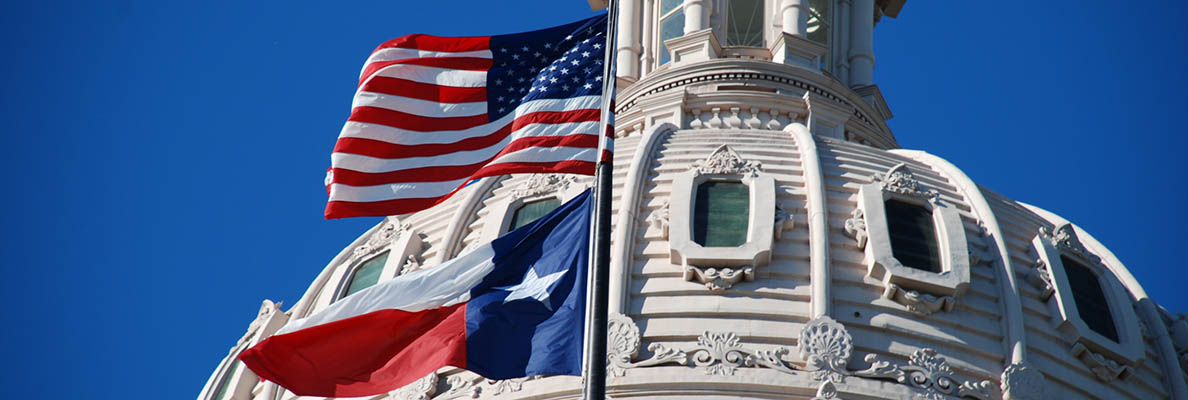 Texas Capitol dome with American and Texas flags