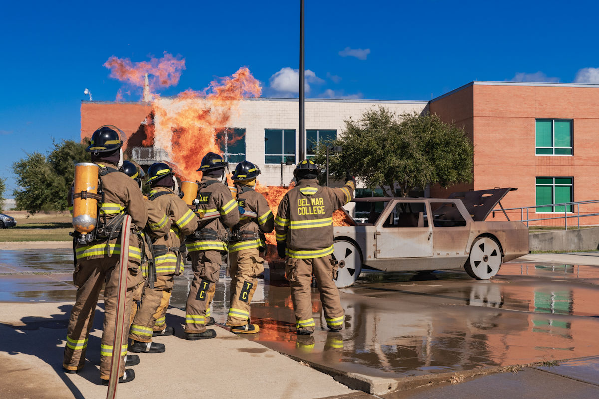 Students extinguishing demonstration car fire