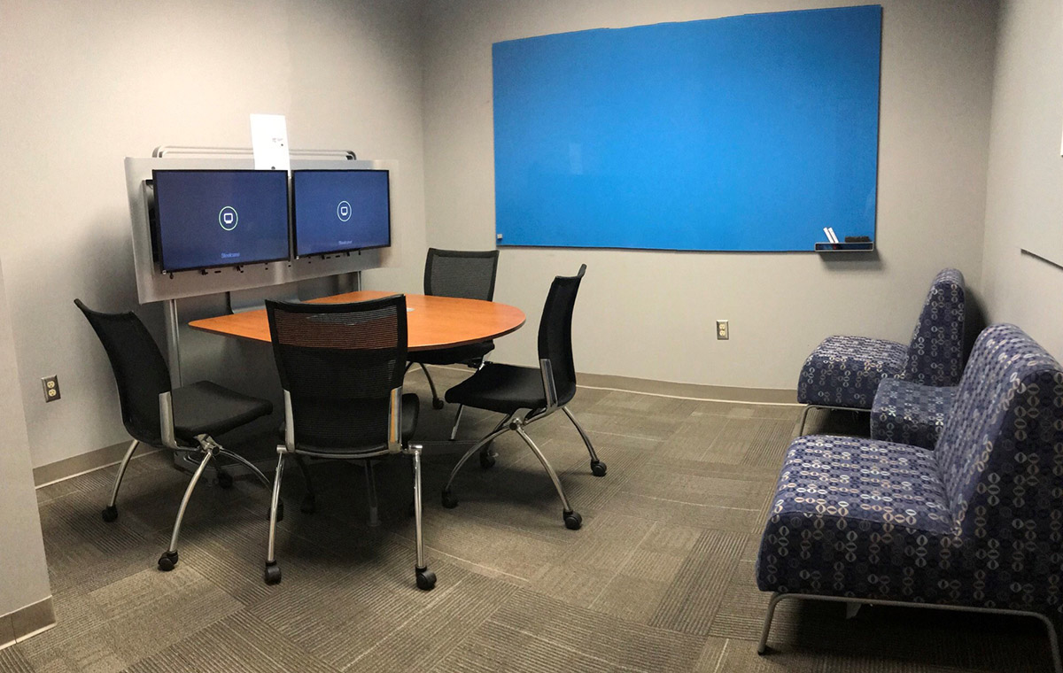 Media escape room with large screen and desk