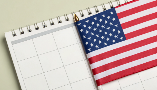 a desk calendar with a small United States flag on it
