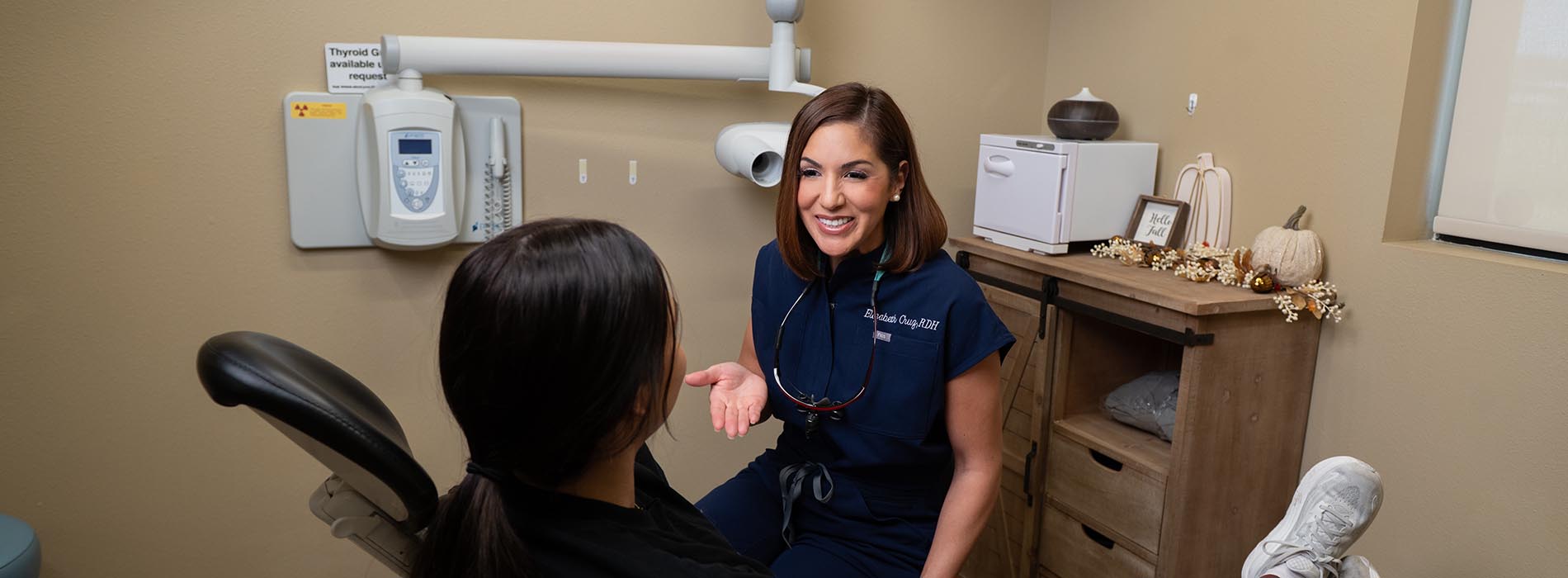 DMC graduate Elizabeth Cruz assisting a dental patient