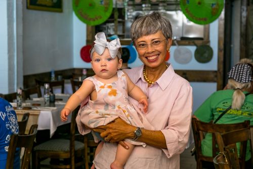 woman holding baby in restaurant