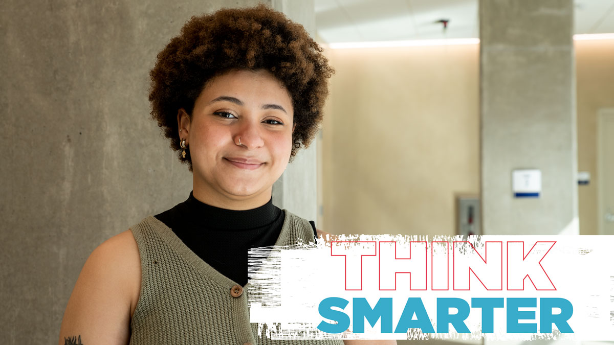 Female student standing in hallway: think smarter