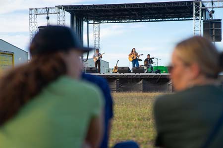 Audience members enjoying Kat Hasty's performance